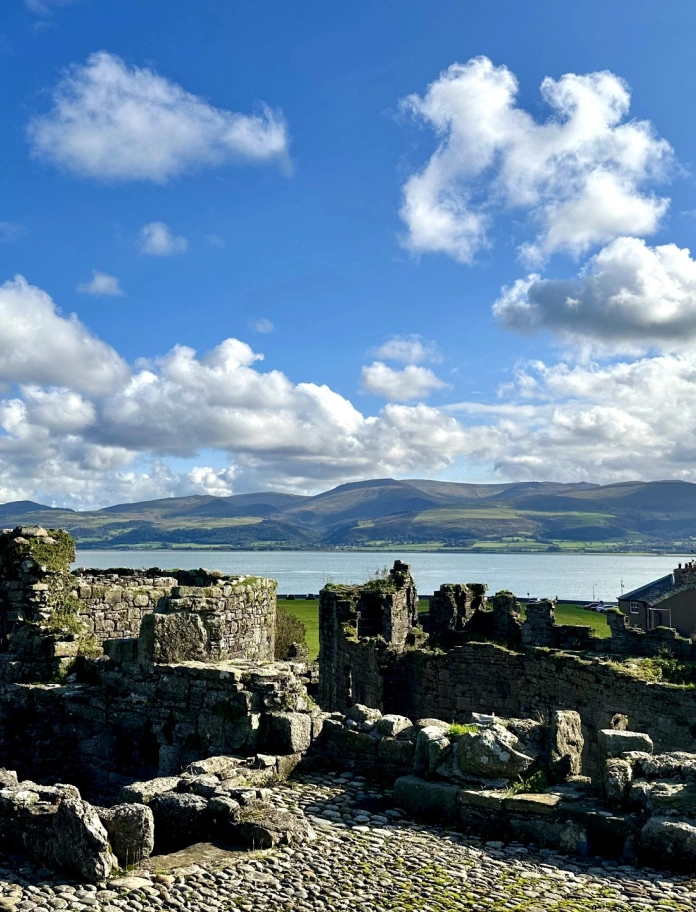 castle ruins and view of sea and mountains.