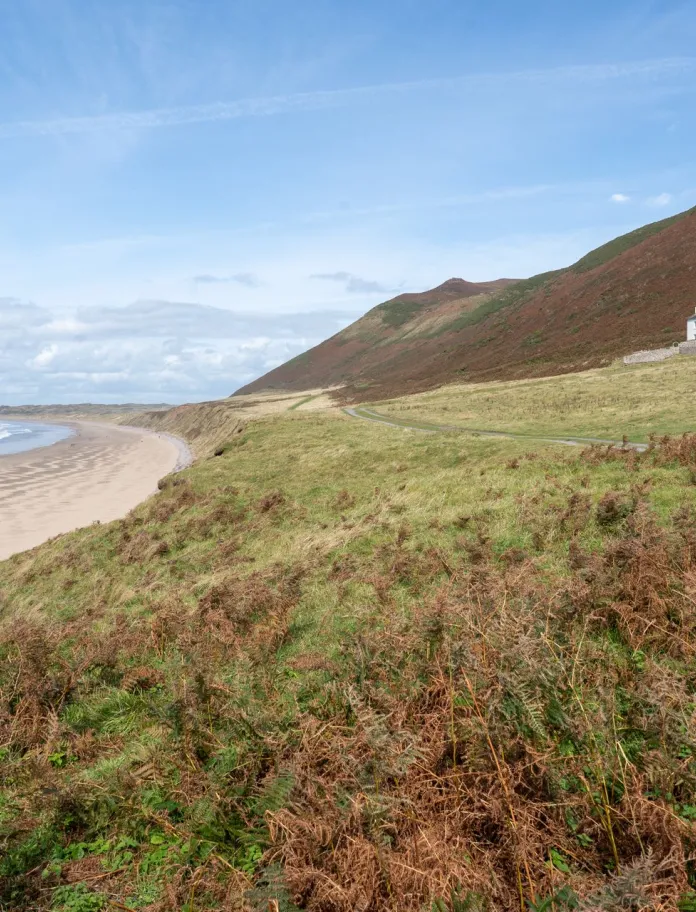 Sweeping sandy beach with a rectory positioned looking at the sea front