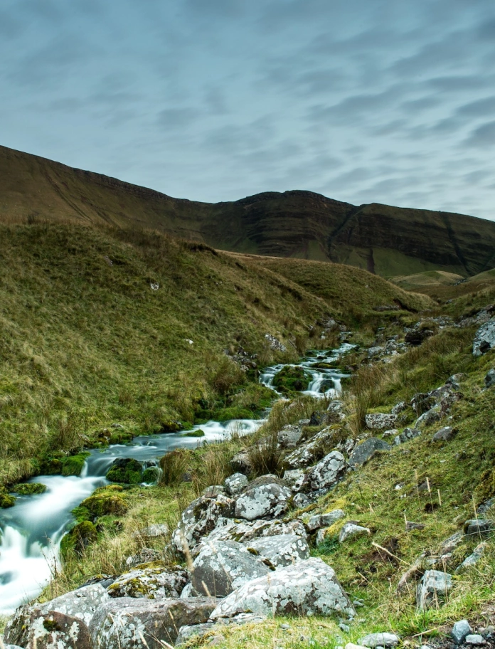 hill and flowing stream.