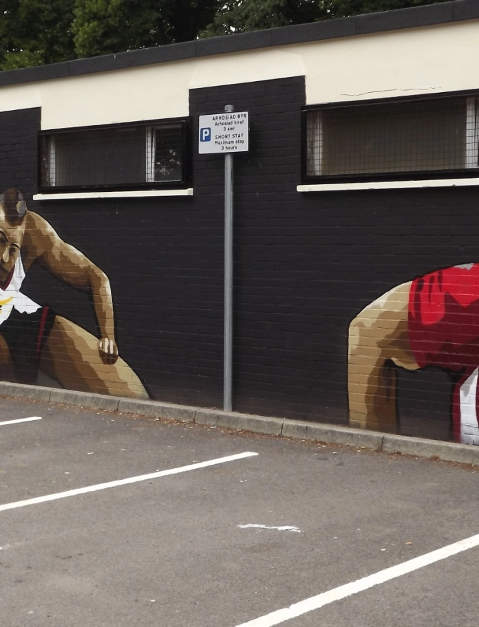 mural of Gareth Bale, Colin Jackson and Sam Warburton on changing room wall.