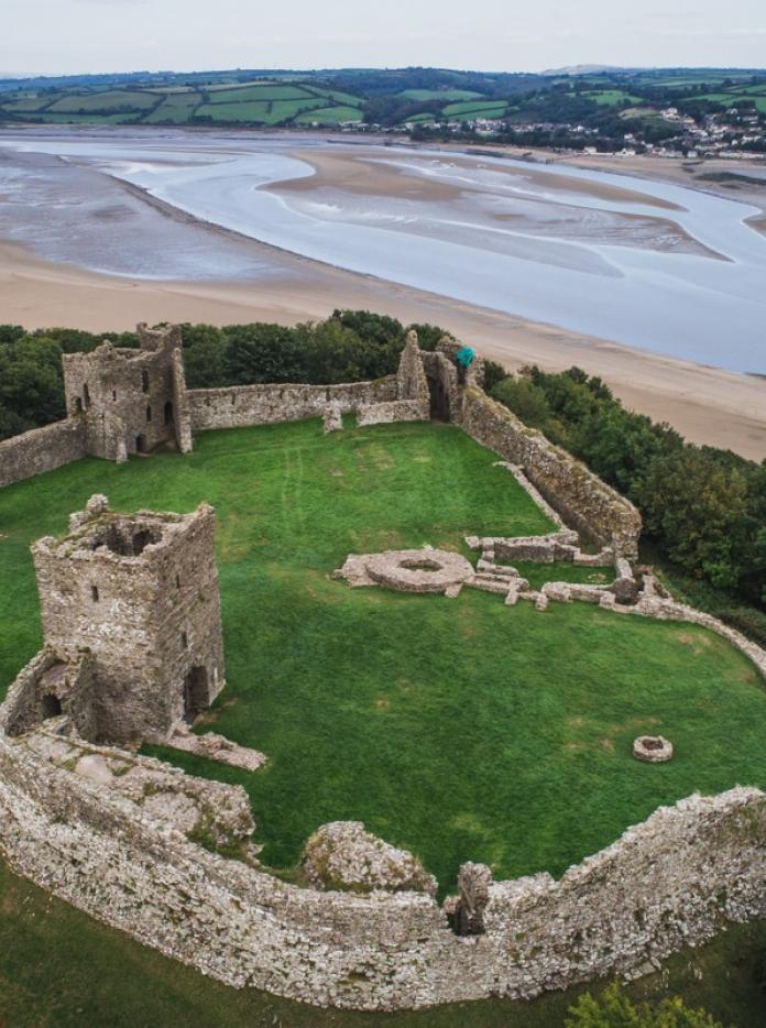 The ruins of Llansteffan Castle in Carmarthenshire from above, with the River Tywi estuary in the background.