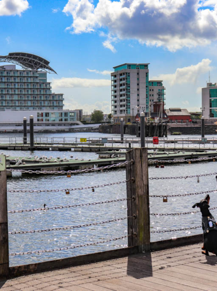 Lottie and her dog Arty looking over the water