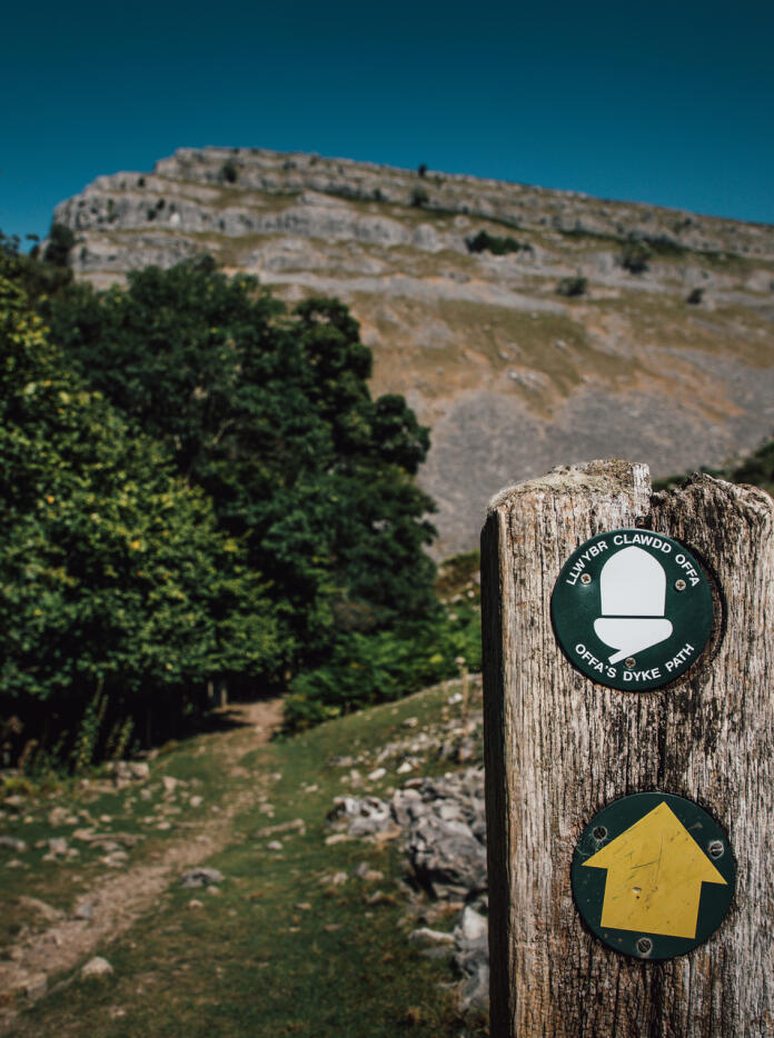 A signpost pointing to the top of a mountain.