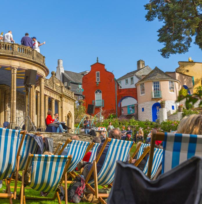 Image of colourful houses at Portmeirion with deck chairs in the front of the picture