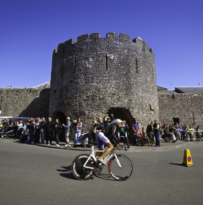 Cyclist on bike passing Five Arches, Tenby
