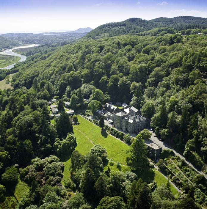 An aerial shot of Plas Tan Y Bwlch, Snowdonia, surrounded by forest.