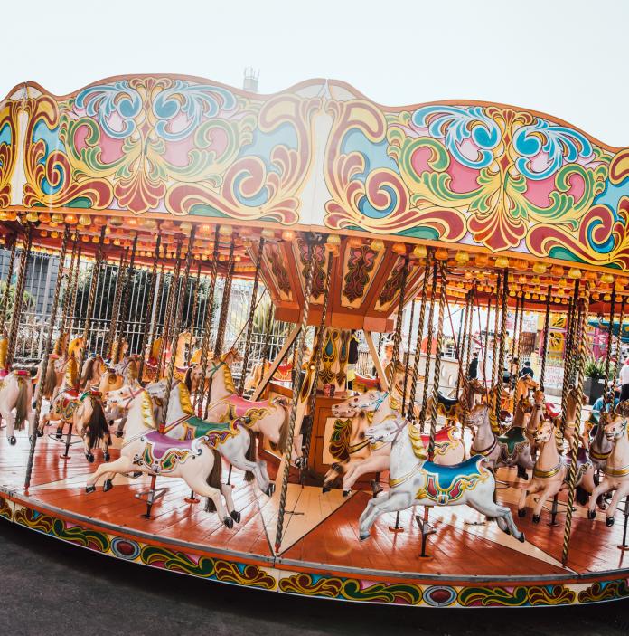 Funfair carousel with horses.