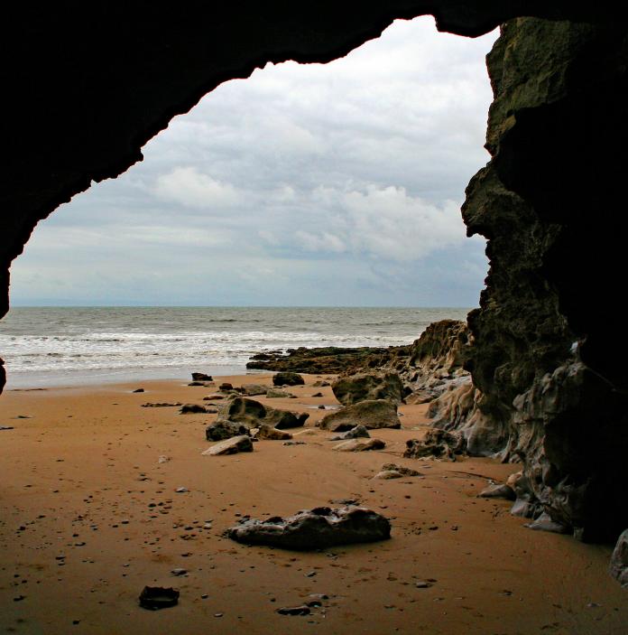 inside cave looking out to the beach.