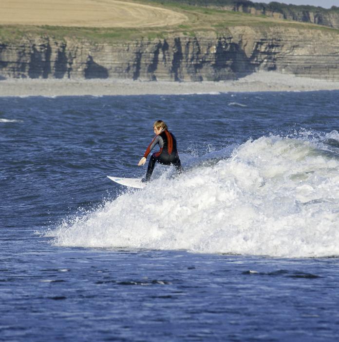 young male surfing.