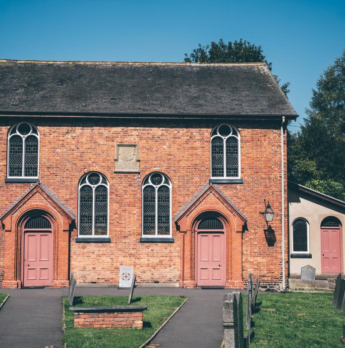 exterior of red brick chapel.