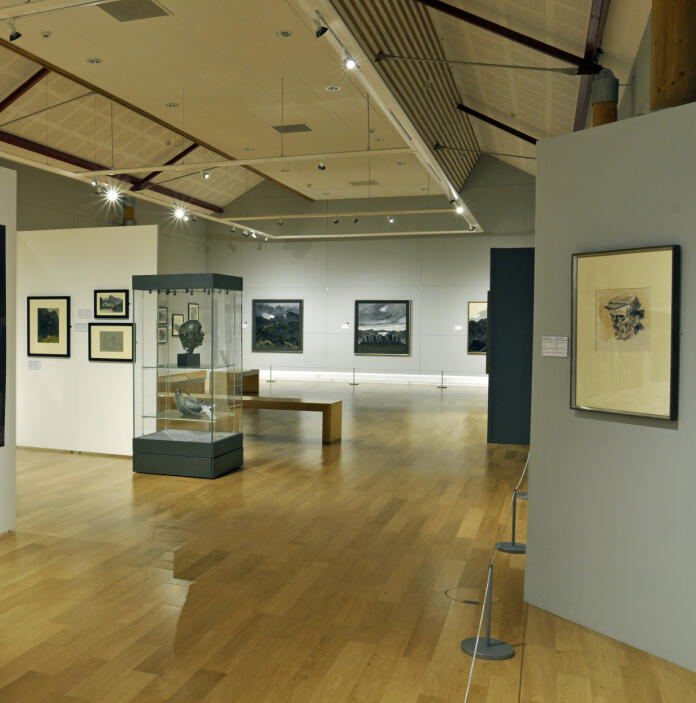 art gallery with works of art and signage Sir Kyffin Williams collection, Oriel Môn museum and gallery.