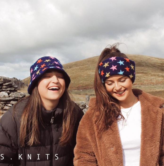 Two girls modelling a hat and scarf from the Alis Knit Collection