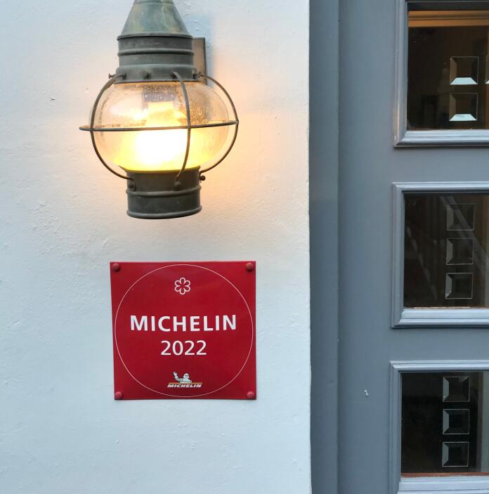 A red sign on an exterior wall with 'MICHELIN 2022' on.