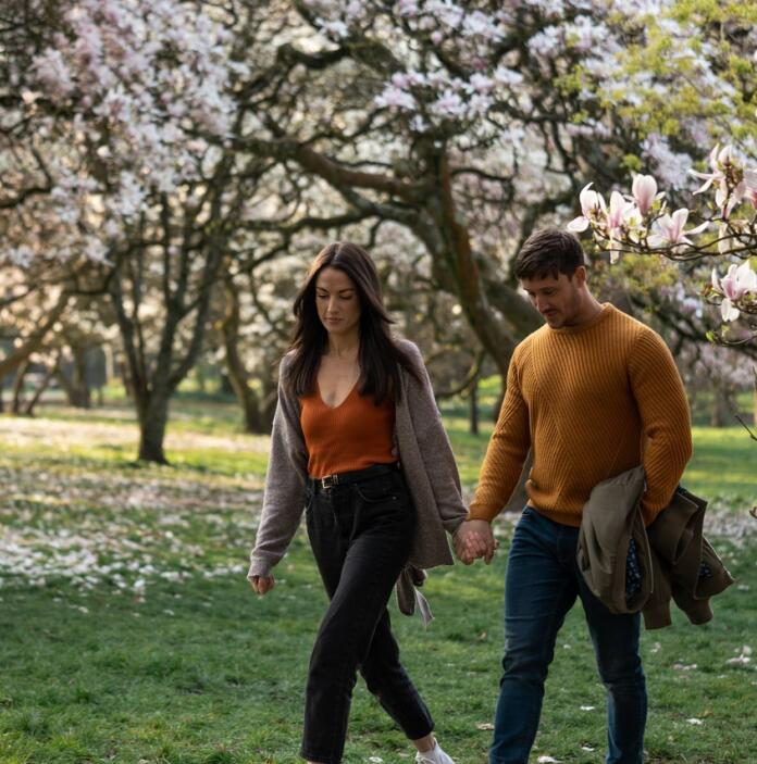 couple walking near blossoming trees in Bute Park, Cardiff