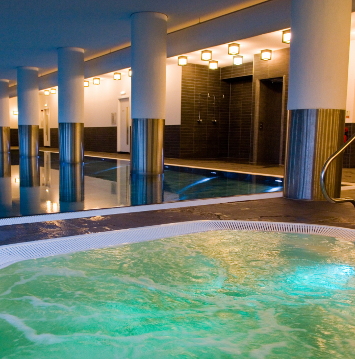 A jacuzzi and swimming pool at an indoor spa.