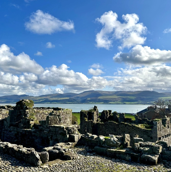castle ruins and view of sea and mountains.