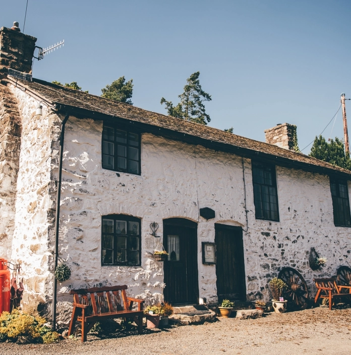 exterior of whitewashed stone chapel.