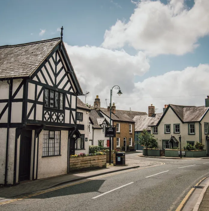 Quiet street scene with traditional buildings that have a strong Tudor / black-and-white timbered style.