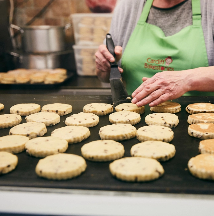 Woman cooking Welsh cakes.