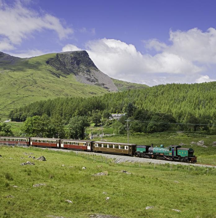 Welsh Highland Railway passing through Gwyrfai valley, with nantlle ridge in background.
