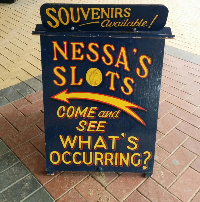 Nessa'S Slots sandwich board.