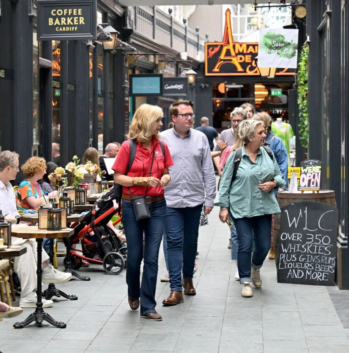 People on a food tour in a busy arcade.