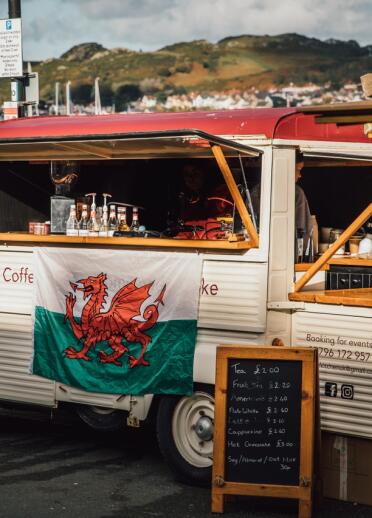A vintage coffee van on a seafront.
