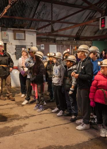 School group kitting up with guide, Big Pit National Coal Museum