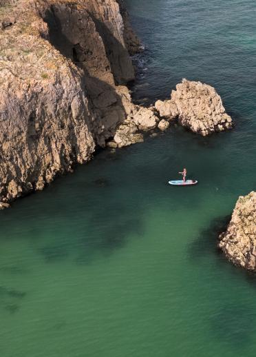Stand up paddleboarder in Barafundle Bay.