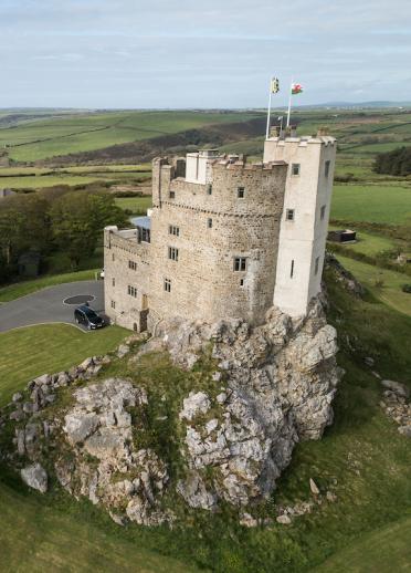 Roch Castle set in the green fields of Pembrokeshire.