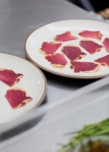 Close-up of two plates with cured Welsh lamb