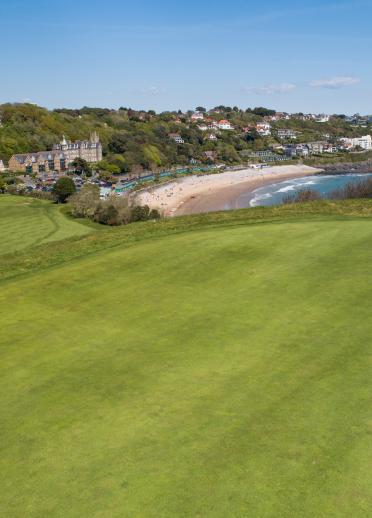 golf course with beach in background.