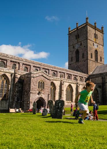 Young boy playing in front of St Davids Cathedral