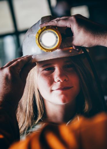 Trying on a miner's helmet at Big Pit National Coal Museum