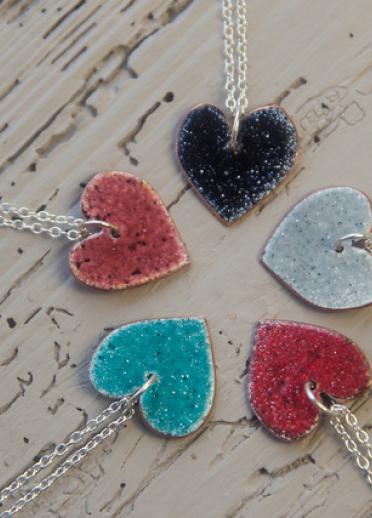 Five enamel heart necklaces in different colours