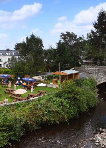 beer garden and canal with stone bridge.