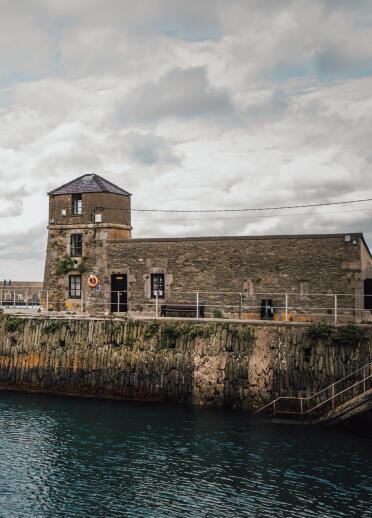stone building on harbour.