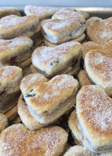 pile of heart shaped Welsh cakes.