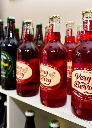 Bottles of cider labelled Tomos Watkin Very Berry.