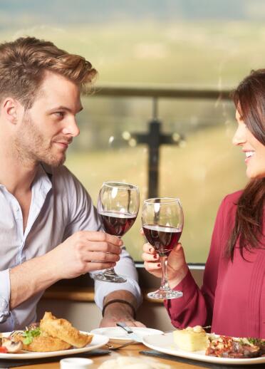 Couple enjoying a meal and a glass of wine