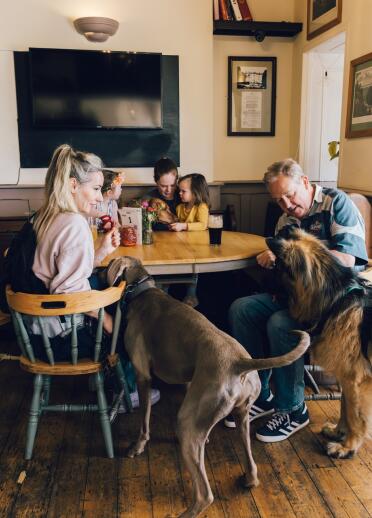 family and two dogs in pub.