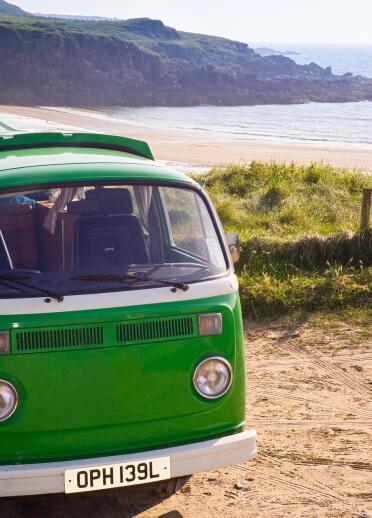 Volkswagen campervan close to beach in Anglesey, North Wales.