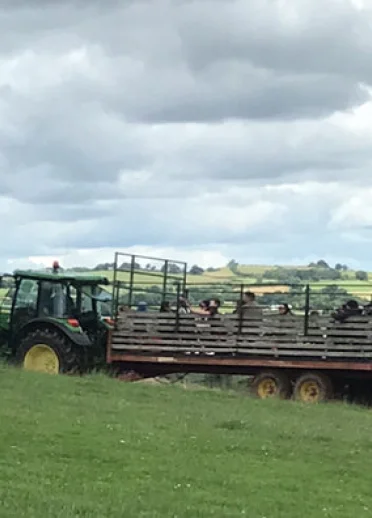 tractor and trailer in field.
