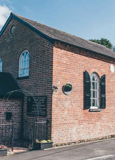 exterior of red brick chapel.