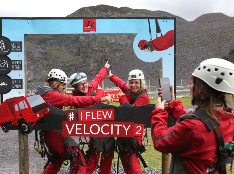 A group celebrating soaring down the zip wire at  Zip World Velocity, Penrhyn Quarry, Bethesda.
