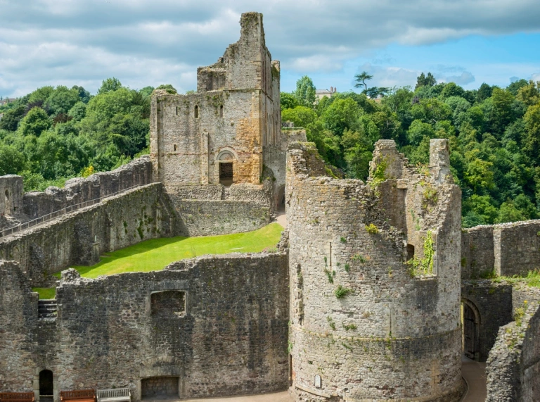 Two towers inside Chepstow Castle showing the ruins of war.