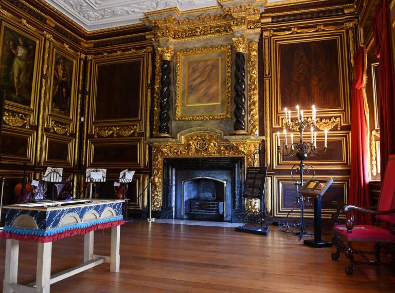 One of the impressive state rooms featuring a fireplace and candelabra at Tredegar House.