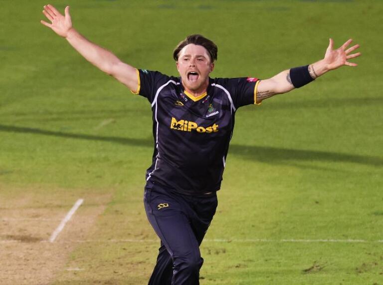 A bowler celebrating taking a wicket in a cricket match