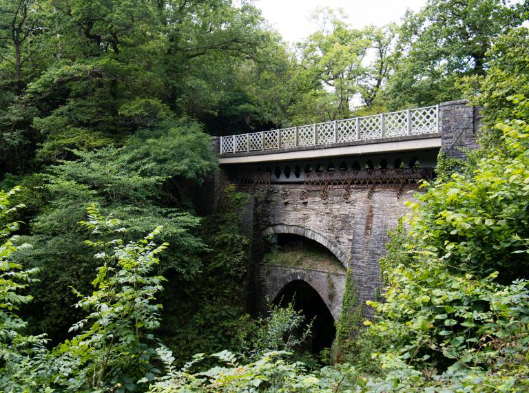 View of the three bridges at Devil's Bridge amongst woodland