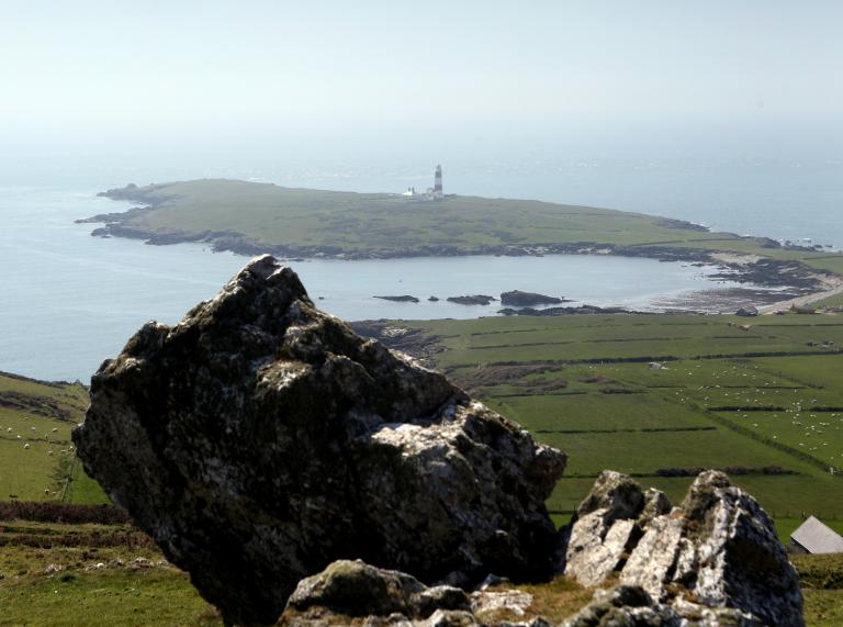 View of Bardsey Island with the lighthouse in the distance